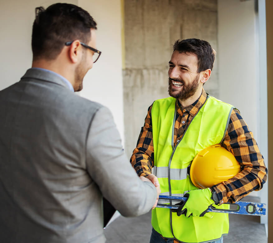 smiling inspector shaking hands with client